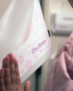 A Bella Blanket coverlet being removed from a mammogram machine plate