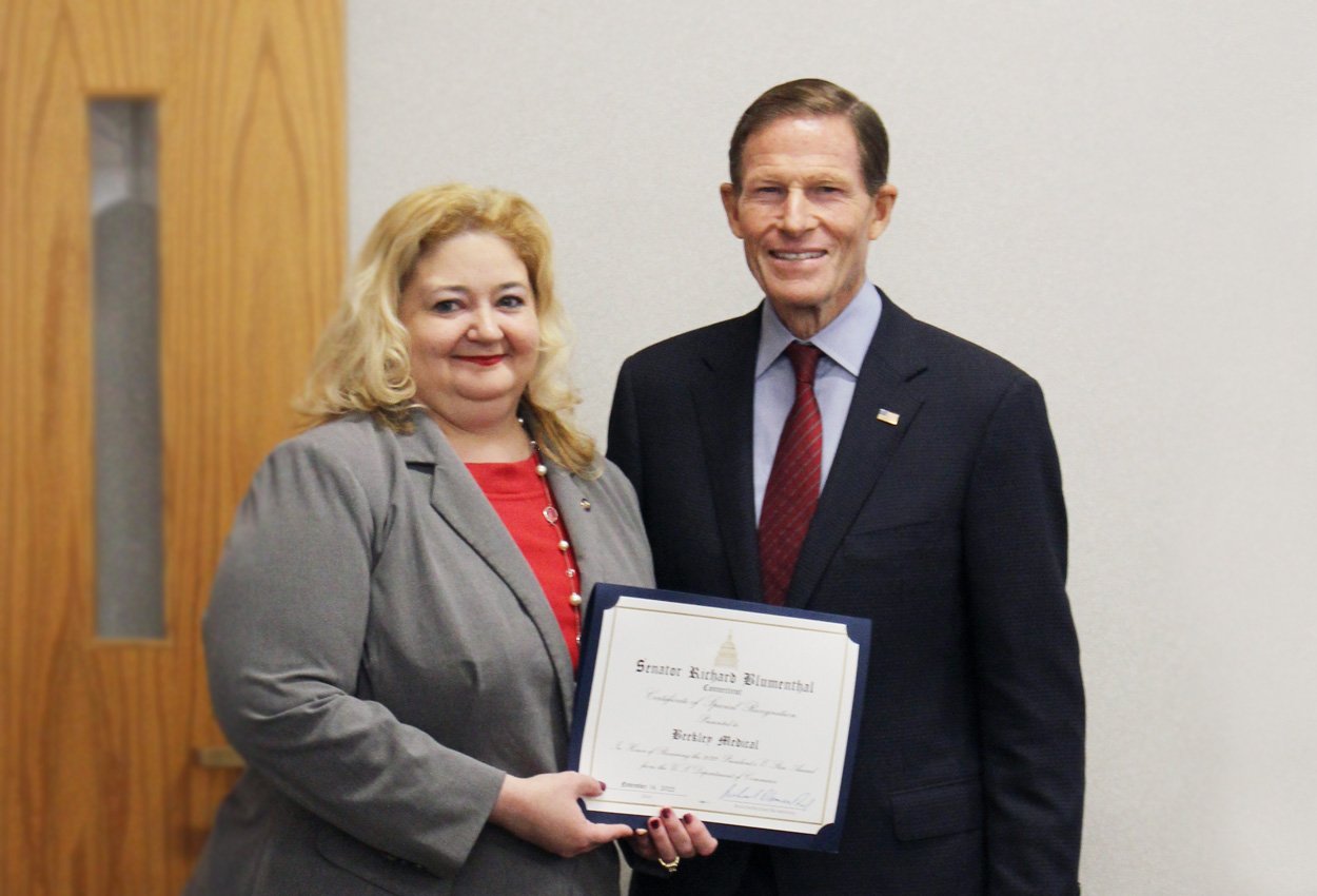 Amy Bosco and Senator Blumenthal holding certificate of recognition for President's E-Star Award