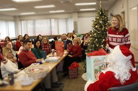 Beekley Secret Santa, 2024. Associates gathered around Santa.