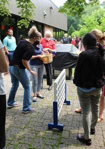 associates playing giant Connect Four game