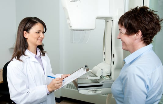 A doctor and patient speaking before a mammogram