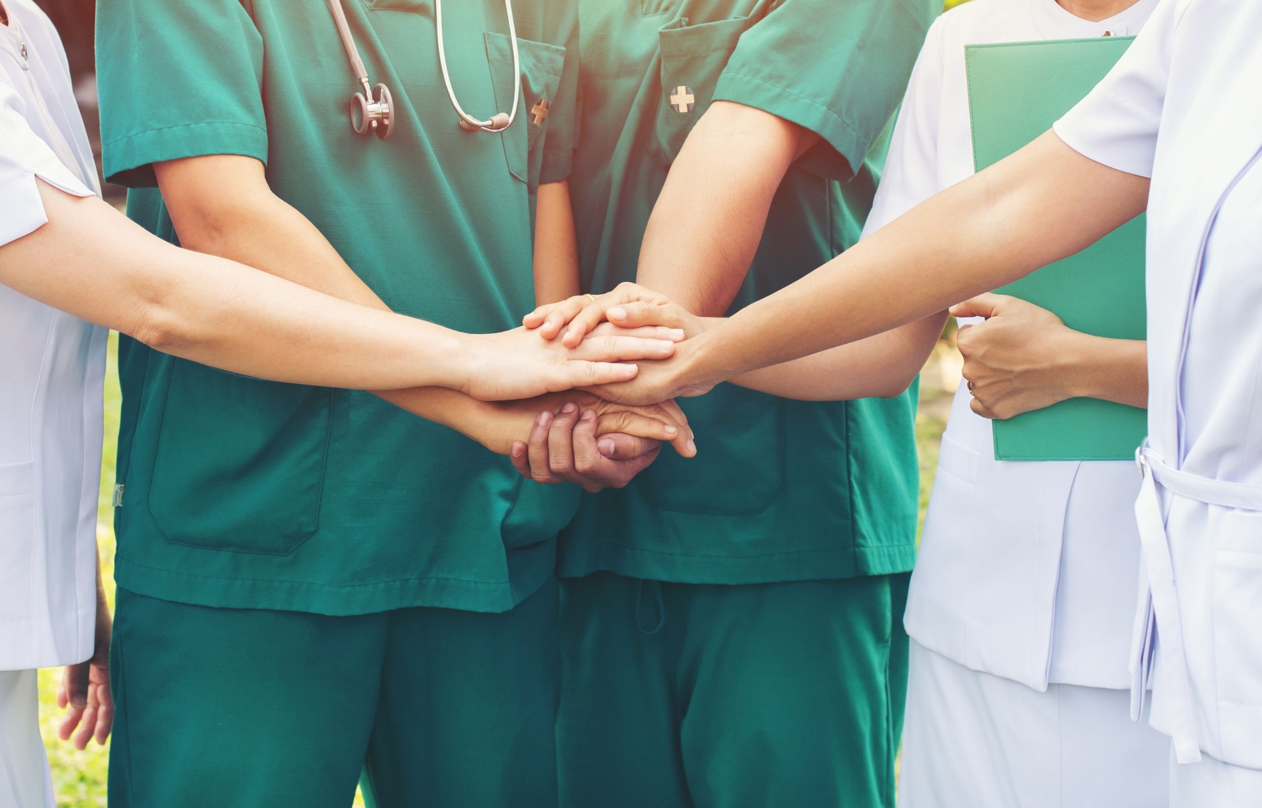 Nurses putting their hands together in a circle