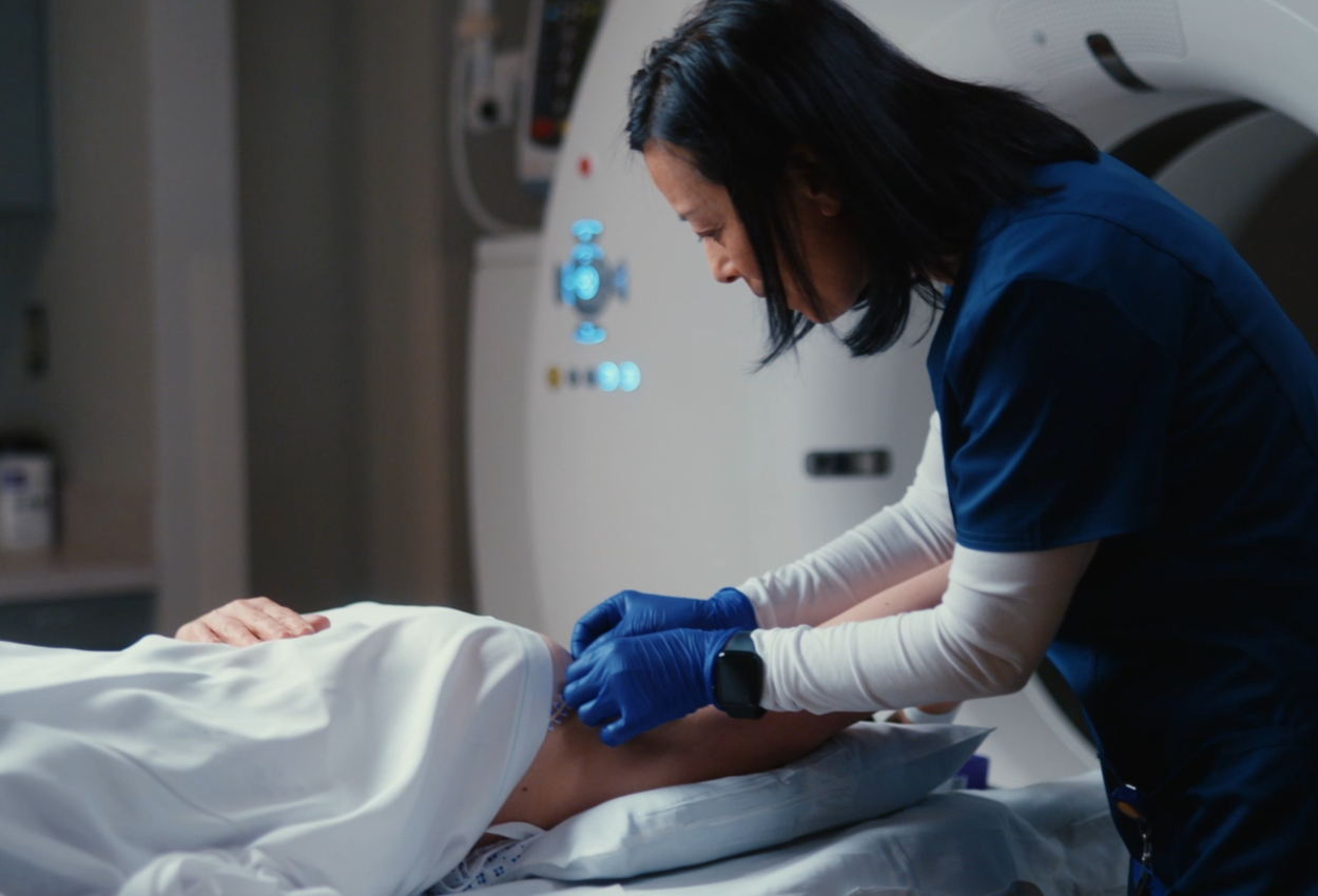 female technician applying RT-Spot skin marker on a patient
