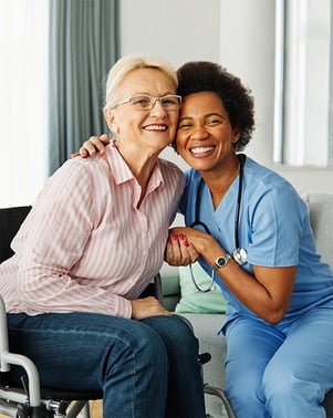 A nurse and patient looking at the camera happily
