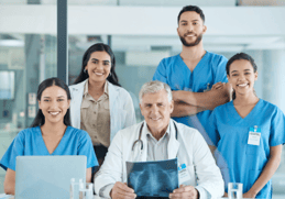 team of five medical imaging professional of various ages and races standing and sitting together