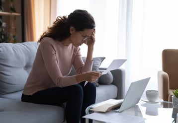 A lady stressed out looking at her medical bill