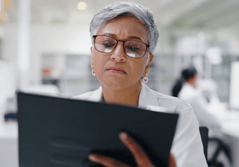 female medical professional looking at a tablet