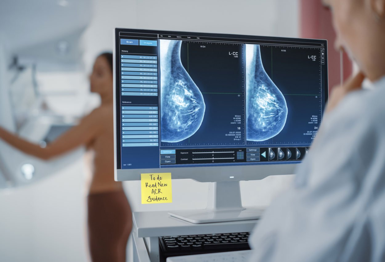 Mammography suite, woman getting mammogram and radiologist looking at x-rays on computer monitor