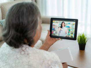 Older lady on telehealth call with pharmacist over tablet device