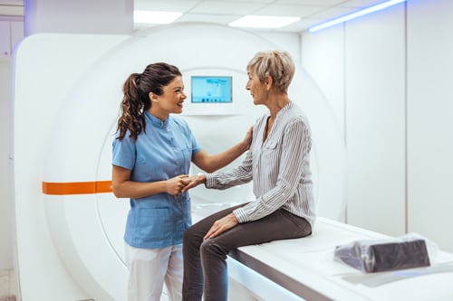Technologist and patient in front of a MRI machine