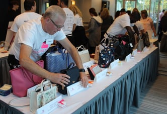 John arranging the handbags for the event