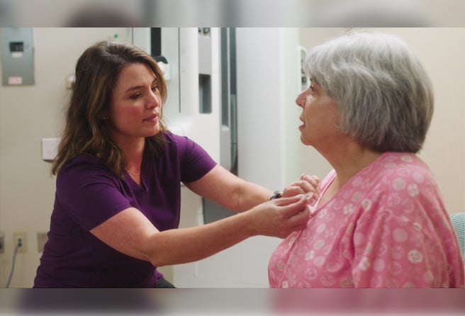 Tech applying Beekley Medical SPOT skin marker to patient before mammogram