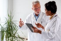 two medical physicists discussing a treatment planplan