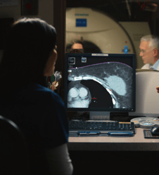 Doctor and tech looking at a CT scan monitor