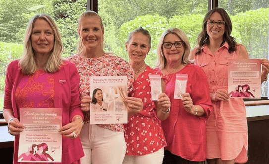 Beekley team holding our new Breast Cancer Month posters