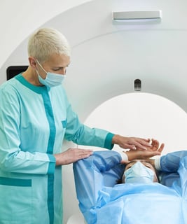 A technologist preparing a patient on a CT machine.
