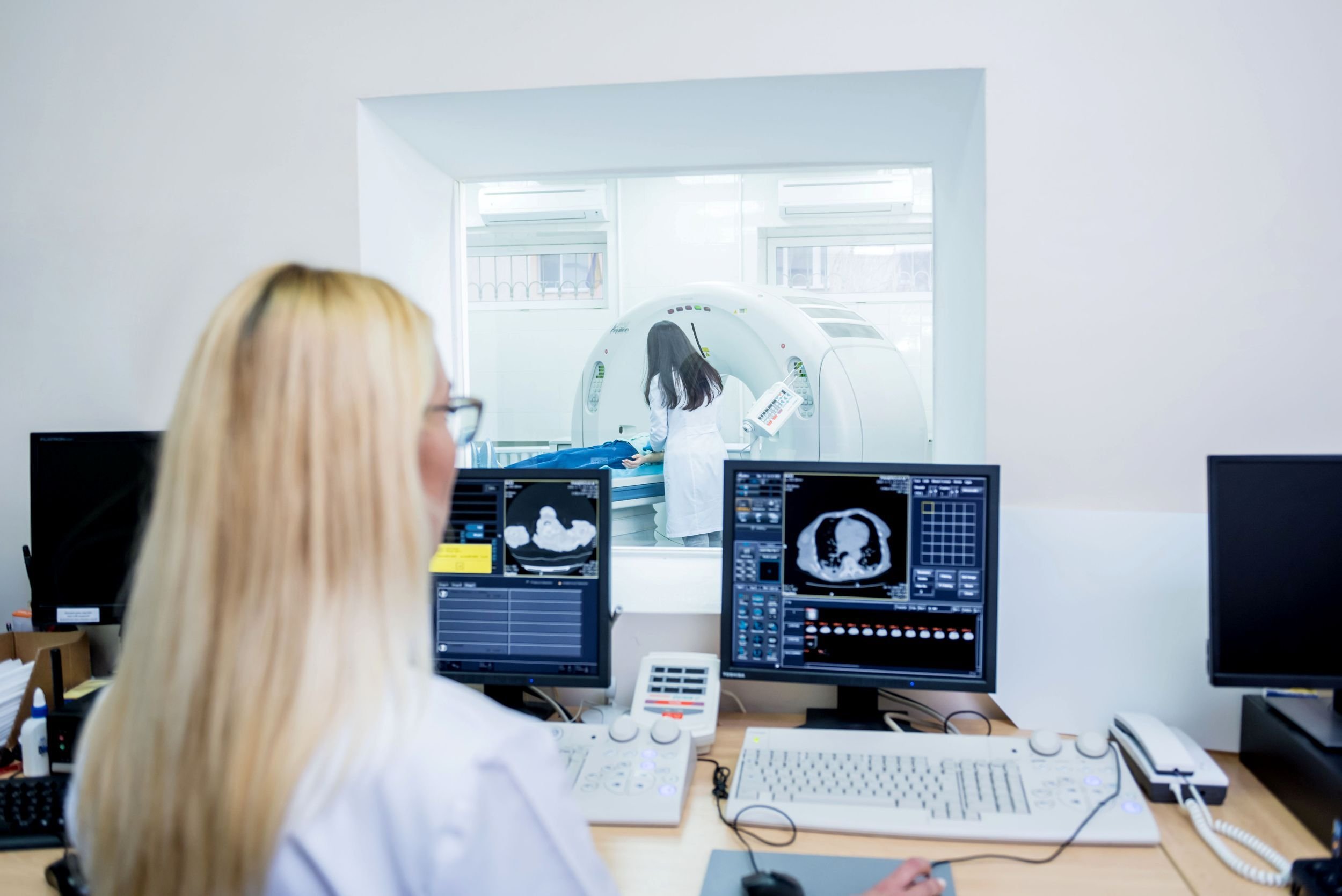A technologist looking at screens during CT simulation