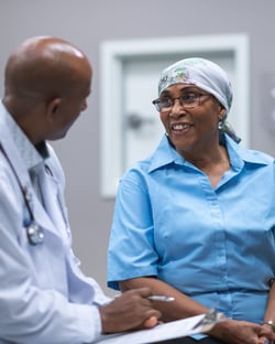 A doctor talking to a Black female patient.