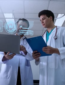 Two doctors looking at screens with AI overlays