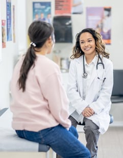 A doctor talking to a female patient.