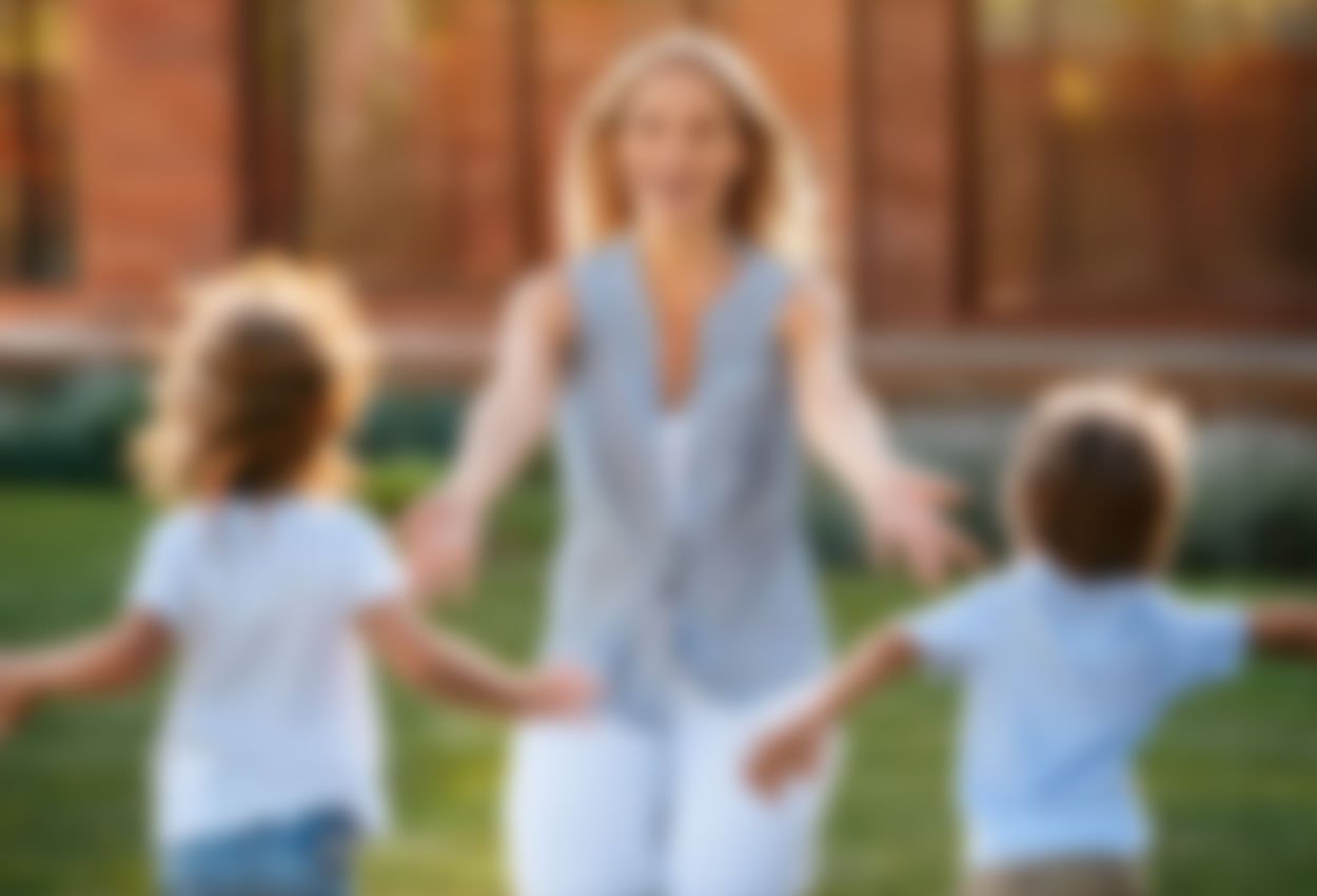 young children running into their mother's open arms