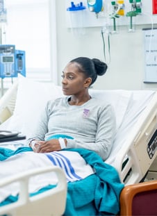 A patient in a bed recovering from surgery