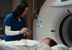 radiation therapist next to patient holding an InkRight packet
