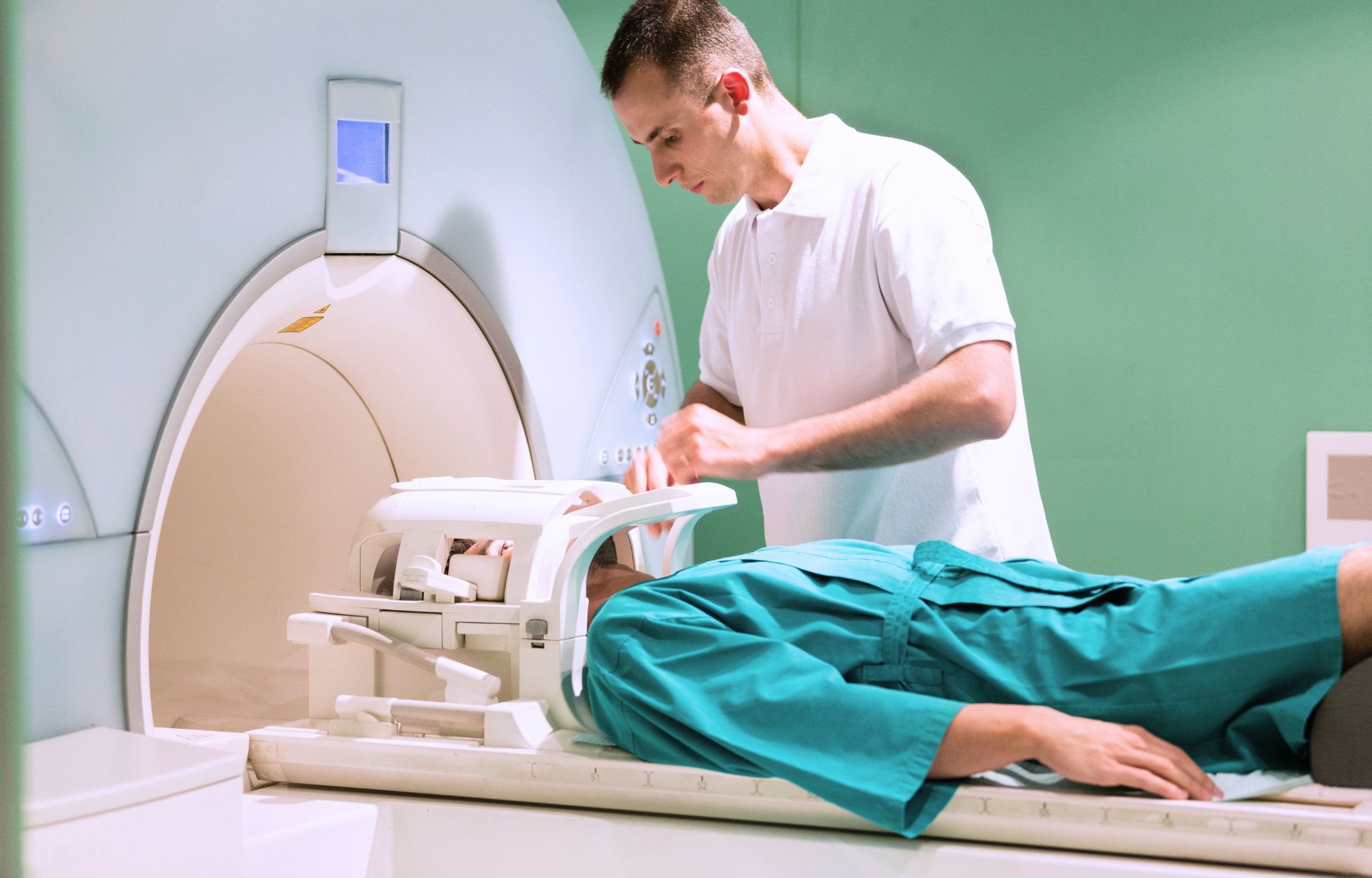 A technologist preparing a patient in a MRI machine