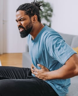 A man holding his stomach in pain.
