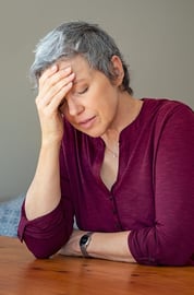 A woman with her head in her hand