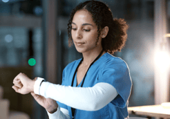 young African American imaging technician looking at her watch