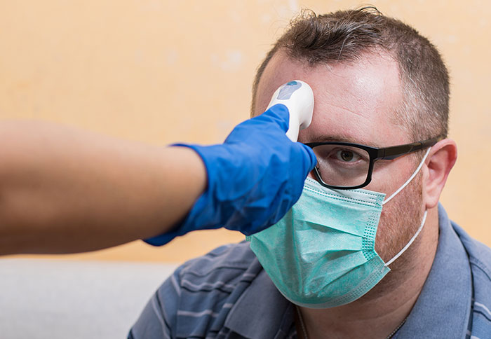 patient getting temperature checked